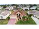 An aerial view of a house with a red brick driveway and well-manicured lawn at 4731 Summerbridge Cir, Leesburg, FL 34748