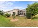 Landscaped backyard with a screened patio at 4731 Summerbridge Cir, Leesburg, FL 34748
