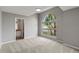 Bright bedroom with carpet flooring and an arched window at 4731 Summerbridge Cir, Leesburg, FL 34748