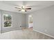Well-lit bedroom with carpet flooring and access to a bathroom at 4731 Summerbridge Cir, Leesburg, FL 34748