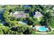 An aerial view of a community with a clubhouse, pool, tennis courts, and other amenities at 4731 Summerbridge Cir, Leesburg, FL 34748