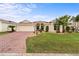 Attractive single-story home with a brick driveway and lush landscaping at 4731 Summerbridge Cir, Leesburg, FL 34748