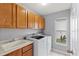 Laundry room with washer, dryer, and cabinets at 4731 Summerbridge Cir, Leesburg, FL 34748