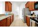 Kitchen with wood cabinets, stainless steel appliances and view of entry at 4814 Cayview Ave # 40613, Orlando, FL 32819