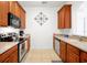Kitchen with wood cabinets, stainless steel appliances, and tile floor at 4814 Cayview Ave # 40613, Orlando, FL 32819