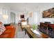 Living room with orange couch and view of dining area and kitchen at 4814 Cayview Ave # 40613, Orlando, FL 32819
