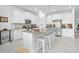 Modern kitchen with white cabinets, large island, and stainless steel appliances at 6115 Claystone Way, Mount Dora, FL 32757
