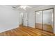 Bedroom with hardwood floors, mirrored closet doors and ceiling fan at 702 Valencia Shores Dr, Winter Garden, FL 34787