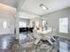 Modern dining room with white table and chairs and chandelier at 2510 Black Lake Blvd, Winter Garden, FL 34787