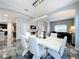 Modern dining room with white table and chairs and chandelier at 2510 Black Lake Blvd, Winter Garden, FL 34787