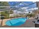 Relaxing screened pool area with lounge chairs and backyard view at 2908 Pembridge St, Kissimmee, FL 34747