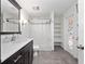 Bathroom with dark brown vanity, shower, and stained glass at 548 Hearthglen Blvd, Winter Garden, FL 34787