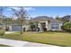 Single-story home with gray garage door, landscaping, and a welcoming front porch at 548 Hearthglen Blvd, Winter Garden, FL 34787