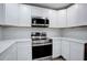 Modern kitchen with white cabinets, stainless steel appliances, and quartz countertops at 58 Pine Trl, Ormond Beach, FL 32174