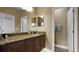 Double vanity bathroom with granite countertops and linen closet at 607 Pensacola Ln, Lake Mary, FL 32746