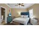 Bedroom with teal dresser and en-suite bathroom at 607 Pensacola Ln, Lake Mary, FL 32746