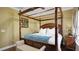 Bedroom with a four poster bed and seashell art at 607 Pensacola Ln, Lake Mary, FL 32746