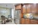 Kitchen with stainless steel refrigerator and wood cabinetry at 607 Pensacola Ln, Lake Mary, FL 32746