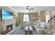 Living room with a sectional sofa, fireplace, and large TV at 607 Pensacola Ln, Lake Mary, FL 32746