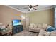 Relaxing living room with sectional sofa and large TV at 607 Pensacola Ln, Lake Mary, FL 32746