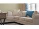 Beige sectional sofa with throw pillows and blanket at 607 Pensacola Ln, Lake Mary, FL 32746