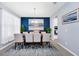 Modern dining room with a large art piece and a view of the kitchen at 609 Big Pine Ave, Minneola, FL 34715