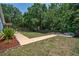 Landscaped backyard with a walkway and mature trees at 612 Shoal Creek Dr, Ocoee, FL 34761