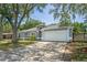 Gray house with a white garage door and long driveway at 612 Shoal Creek Dr, Ocoee, FL 34761