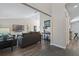 Living room with gray sectional and view into kitchen at 612 Shoal Creek Dr, Ocoee, FL 34761