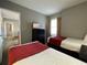 Bedroom with two twin beds and a view into another room at 6165 Carrier Dr # 2401, Orlando, FL 32819