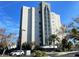 Modern high rise building with palm trees at 6165 Carrier Dr # 2401, Orlando, FL 32819