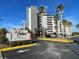 Hotel exterior with palm trees and ample parking at 6165 Carrier Dr # 2401, Orlando, FL 32819