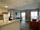 Living room with sofa, table, and kitchen view at 6165 Carrier Dr # 2401, Orlando, FL 32819