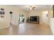 Living room with tile floors, TV stand, and sliding door access to backyard at 6213 Point Hancock Dr, Winter Garden, FL 34787