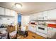 White kitchen with laminate floors, appliances, and red countertops at 6522 Glen Meadow Loop, Lakeland, FL 33810