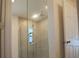 Bathroom with a tiled shower and glass enclosure at 6805 Serpent Hawk Lane St, Howey In The Hills, FL 34737
