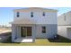 Two-story home's back features a covered patio and grassy yard at 6805 Serpent Hawk Lane St, Howey In The Hills, FL 34737