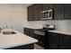 Modern kitchen with stainless steel appliances and an island at 6805 Serpent Hawk Lane St, Howey In The Hills, FL 34737