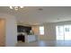 Open floor plan with modern kitchen, dining area, and access to patio at 6805 Serpent Hawk Lane St, Howey In The Hills, FL 34737
