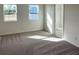 Spacious bedroom with carpeted floor and large windows, showing a view of other homes at 6858 Spanish Imperial St, Howey In The Hills, FL 34737