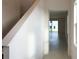 Bright foyer with tile flooring, staircase, and view into living area at 6858 Spanish Imperial St, Howey In The Hills, FL 34737