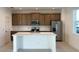 Modern kitchen with island, stainless steel appliances, and wood cabinets at 6858 Spanish Imperial St, Howey In The Hills, FL 34737