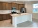 Modern kitchen with island, stainless steel appliances, and wood cabinets at 6858 Spanish Imperial St, Howey In The Hills, FL 34737