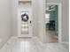 Bright entryway with white door and view into home office at 1380 Clear Brook Pl, St Cloud, FL 34772