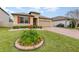 Landscaped front yard with a brick driveway and house at 1380 Clear Brook Pl, St Cloud, FL 34772
