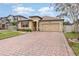 Two-story house with a brick driveway and landscaping at 1380 Clear Brook Pl, St Cloud, FL 34772