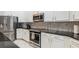 Modern kitchen with stainless steel appliances and white cabinets at 1380 Clear Brook Pl, St Cloud, FL 34772