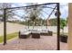 Covered patio with sectional sofa and fire pit at 1380 Clear Brook Pl, St Cloud, FL 34772