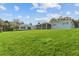 House situated on a large grassy lot with a view of the backyard at 1409 Lake Marion Dr, Apopka, FL 32712