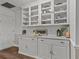 Butlers pantry with white cabinets and glass-front display shelves at 1409 Lake Marion Dr, Apopka, FL 32712